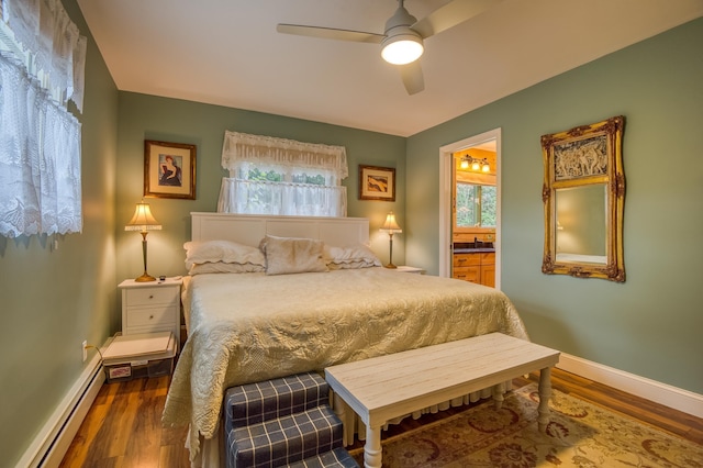 406 Partridge Lake Rd, Littleton, NH 03561 - bedroom featuring a baseboard radiator, wood finished floors, baseboards, and connected bathroom