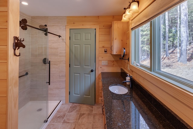 406 Partridge Lake Rd, Littleton, NH 03561 - bathroom with a shower stall, tile patterned flooring, wood walls, and vanity