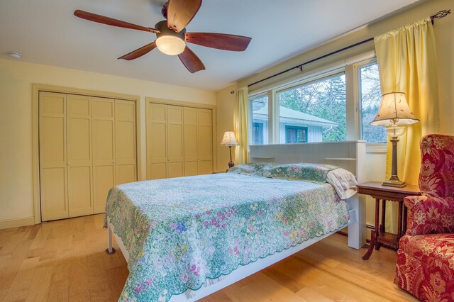 406 Partridge Lake Rd, Littleton, NH 03561 - bedroom with light wood finished floors, two closets, and ceiling fan