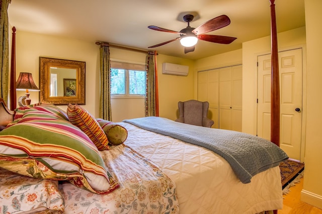 406 Partridge Lake Rd, Littleton, NH 03561 - bedroom with a wall unit AC, wood finished floors, and a ceiling fan