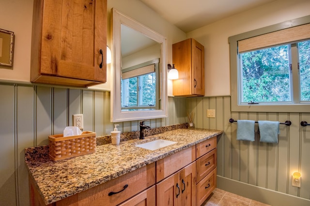 406 Partridge Lake Rd, Littleton, NH 03561 - bathroom featuring a decorative wall, a wainscoted wall, vanity, and tile patterned floors