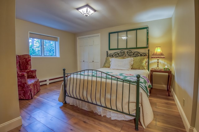 406 Partridge Lake Rd, Littleton, NH 03561 - bedroom with hardwood / wood-style floors, baseboards, a baseboard radiator, and a closet
