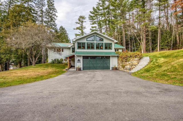 406 Partridge Lake Rd, Littleton, NH 03561 - view of front of house with a garage, driveway, a front lawn, and metal roof