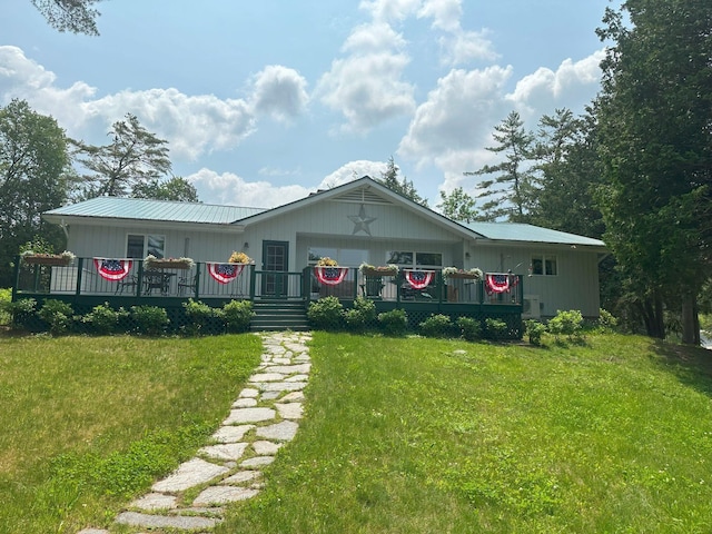 406 Partridge Lake Rd, Littleton, NH 03561 - view of front facade featuring a front yard, a wooden deck, and metal roof