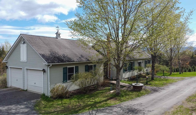 1202 Cotton Rd, Lyndon, VT 05851 - view of front of house with a shingled roof, asphalt driveway, and a garage