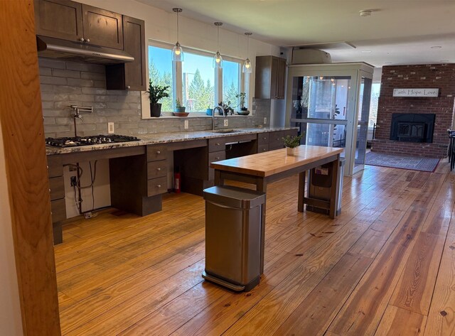 1202 Cotton Rd, Lyndon, VT 05851 - kitchen featuring under cabinet range hood, wood counters, a sink, light wood-style flooring, and gas cooktop