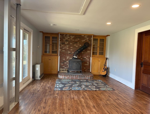 1202 Cotton Rd, Lyndon, VT 05851 - unfurnished living room with a wood stove, wood finished floors, baseboards, and recessed lighting