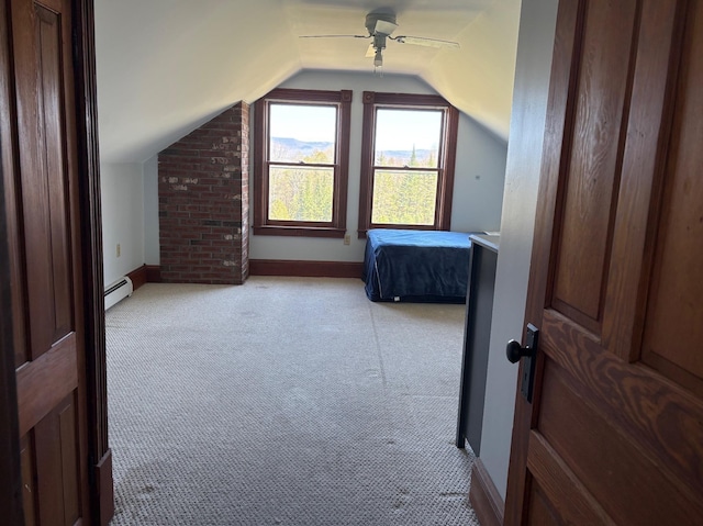 1202 Cotton Rd, Lyndon, VT 05851 - bedroom featuring a baseboard radiator, light colored carpet, lofted ceiling, baseboards, and a ceiling fan