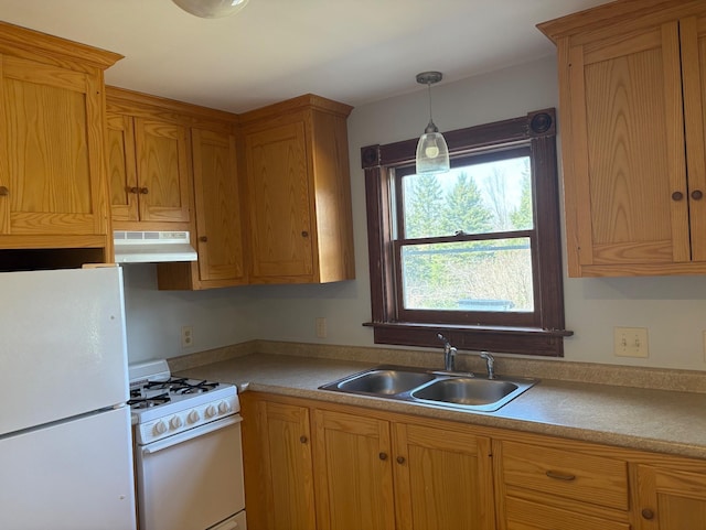 1202 Cotton Rd, Lyndon, VT 05851 - kitchen featuring white appliances, under cabinet range hood, a sink, light countertops, and hanging light fixtures