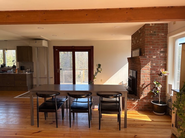 1202 Cotton Rd, Lyndon, VT 05851 - dining space featuring light wood-style floors and a brick fireplace