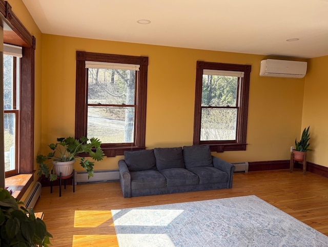 1202 Cotton Rd, Lyndon, VT 05851 - living area featuring an AC wall unit, baseboard heating, light wood finished floors, and recessed lighting