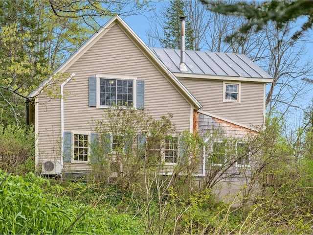 view of side of property with a standing seam roof and metal roof