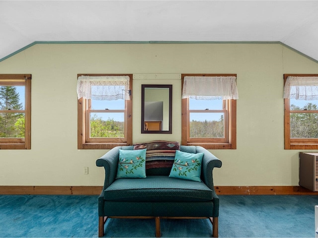 sitting room featuring lofted ceiling, carpet flooring, baseboards, and plenty of natural light