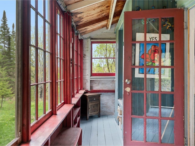 unfurnished sunroom featuring vaulted ceiling