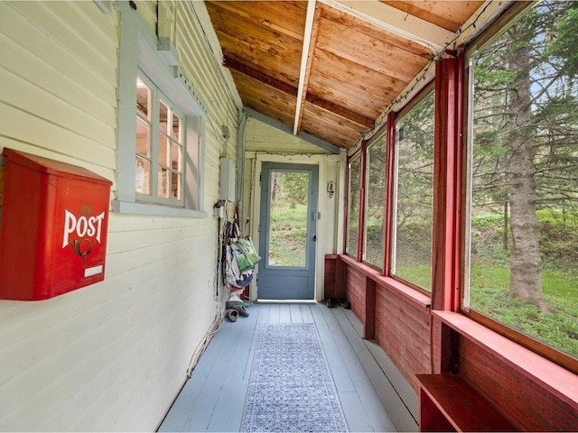 unfurnished sunroom featuring lofted ceiling