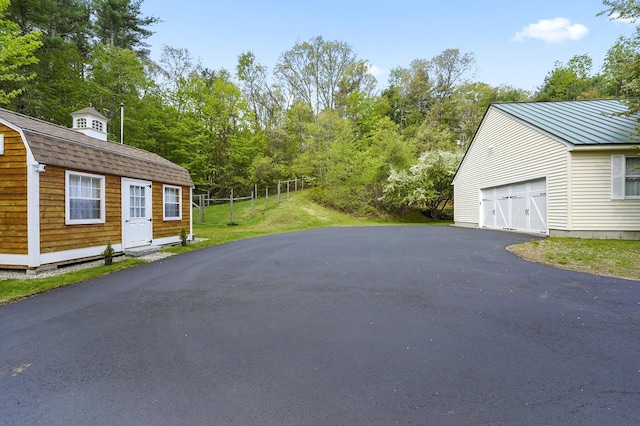 17 Ches Mae Ln, Milford, NH 03055 - view of side of home featuring a gambrel roof, an outbuilding, fence, and view of scattered trees