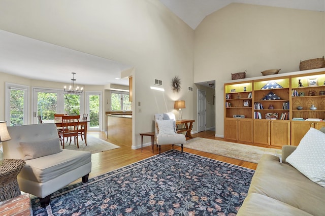 17 Ches Mae Ln, Milford, NH 03055 - living room with a chandelier, light wood-style floors, baseboards, and high vaulted ceiling