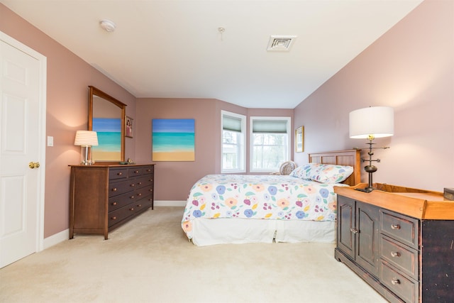 bedroom featuring light carpet and baseboards