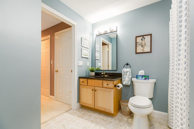 full bath featuring vanity, toilet, baseboards, and tile patterned floors