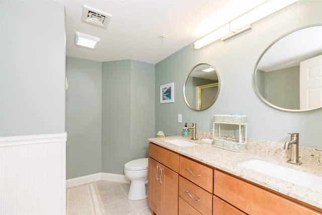 full bathroom featuring tile patterned flooring, toilet, and double vanity