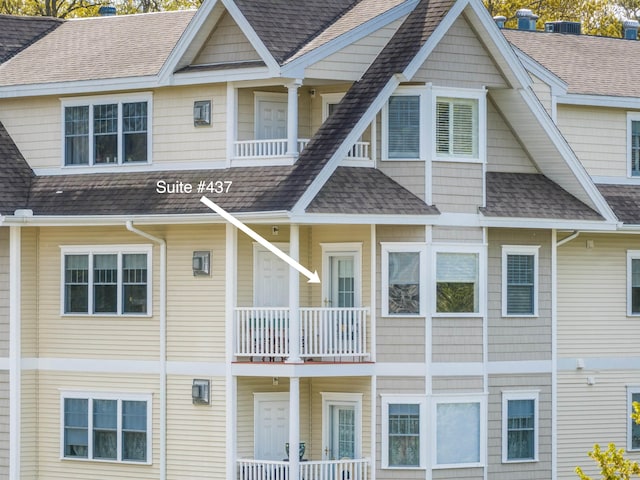 back of house featuring a shingled roof and central air condition unit