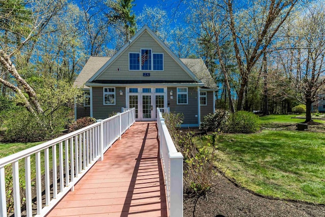 back of property featuring a lawn and french doors