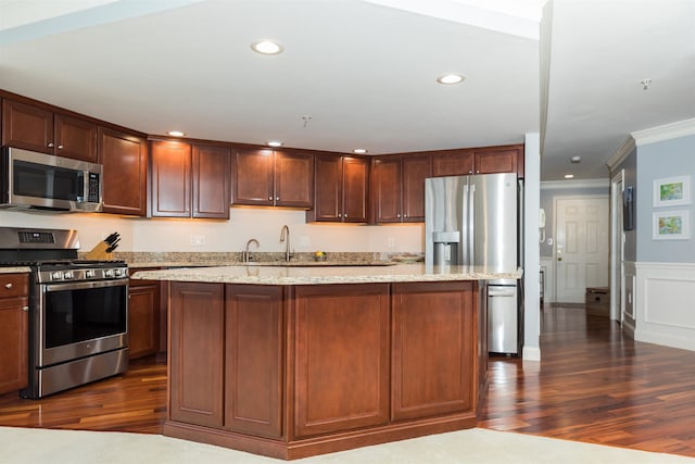 kitchen featuring stainless steel appliances, ornamental molding, dark wood-style floors, light stone countertops, and recessed lighting