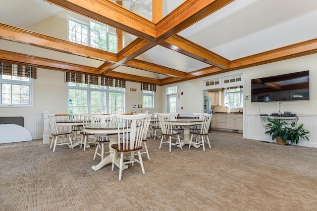 dining space featuring carpet, beamed ceiling, wainscoting, and coffered ceiling
