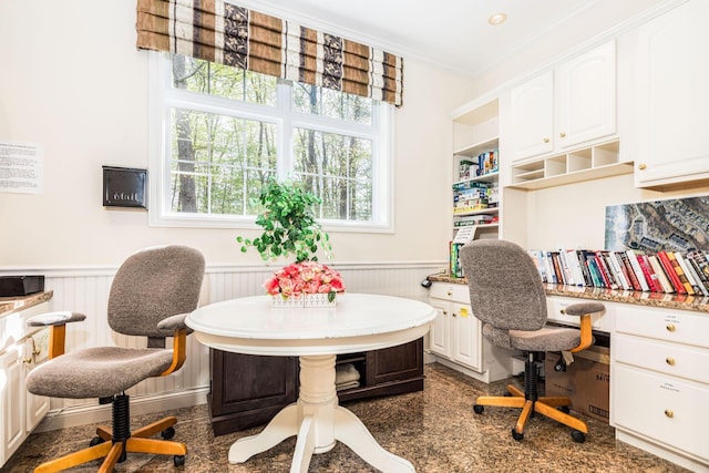 office area with a wainscoted wall and crown molding