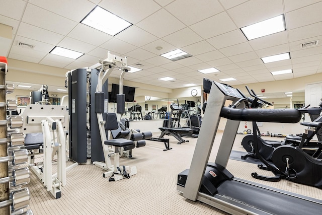 gym with carpet flooring and a paneled ceiling