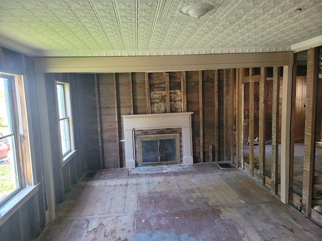 70 Bridge St, Hillsborough, NH 03244 - unfurnished living room featuring a brick fireplace, hardwood / wood-style floors, and an ornate ceiling