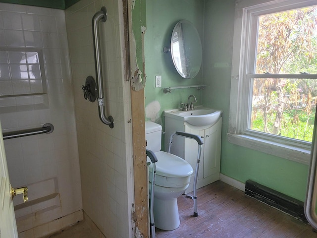 70 Bridge St, Hillsborough, NH 03244 - full bathroom with toilet, a tile shower, wood finished floors, and vanity
