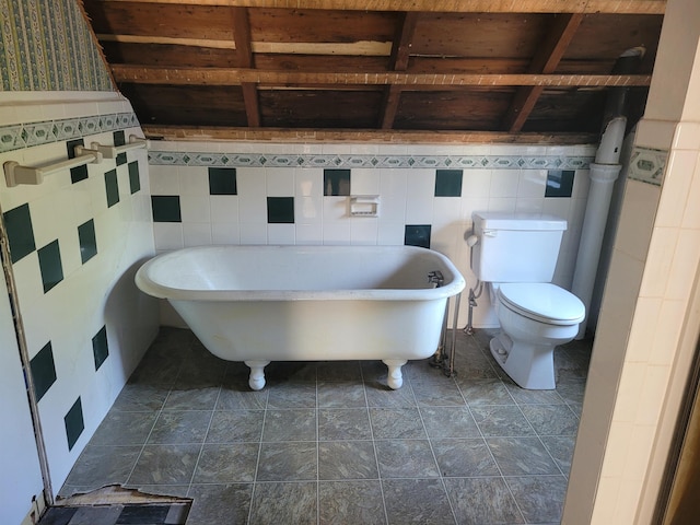 70 Bridge St, Hillsborough, NH 03244 - full bathroom featuring toilet, a freestanding bath, and tile walls