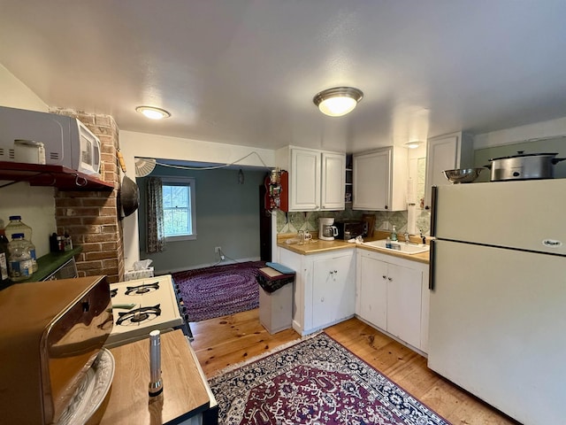 23 Mason Hill Rd, Tamworth, NH 03886 - kitchen featuring freestanding refrigerator, a sink, light wood finished floors, and white cabinetry