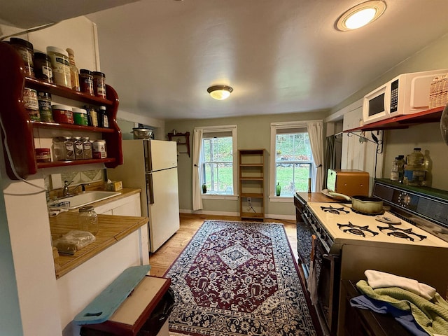 23 Mason Hill Rd, Tamworth, NH 03886 - kitchen with white appliances, a sink, white cabinets, light wood finished floors, and open shelves
