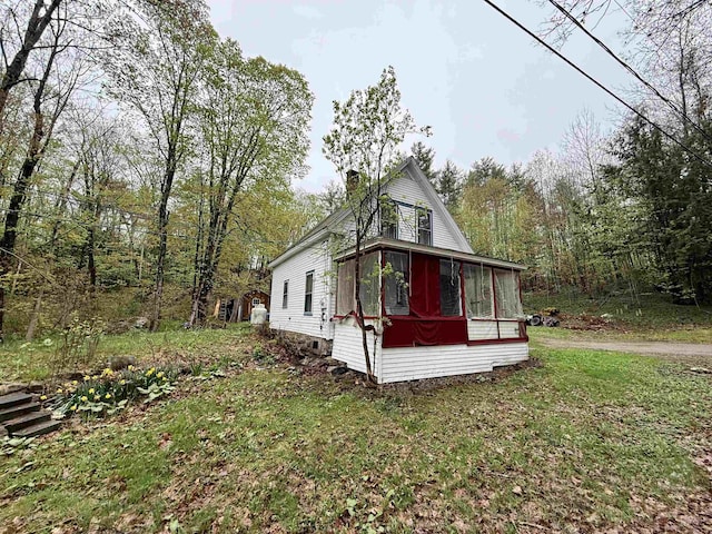 23 Mason Hill Rd, Tamworth, NH 03886 - view of side of property featuring a sunroom, a chimney, and a yard