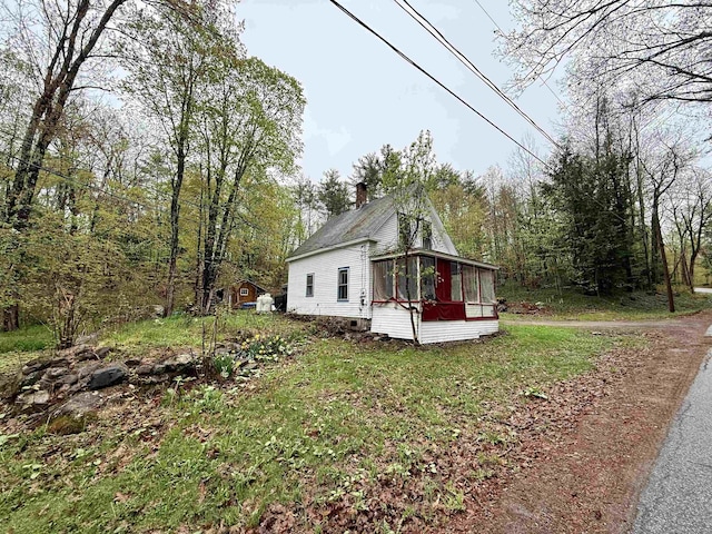 23 Mason Hill Rd, Tamworth, NH 03886 - view of side of home with a sunroom and a chimney