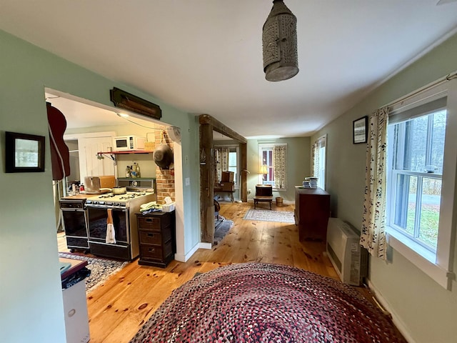 23 Mason Hill Rd, Tamworth, NH 03886 - hallway with light wood finished floors, baseboards, and an AC wall unit