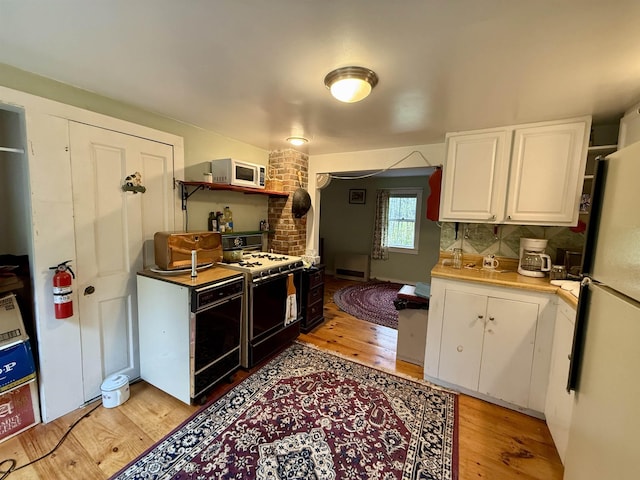 23 Mason Hill Rd, Tamworth, NH 03886 - kitchen with white appliances, white cabinetry, light wood-style floors, and light countertops