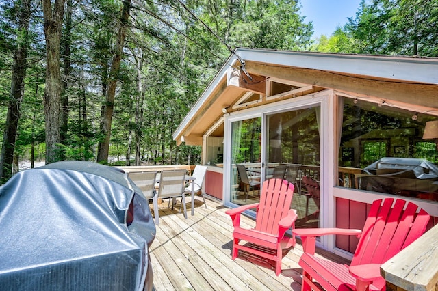 deck featuring a grill and outdoor dining area