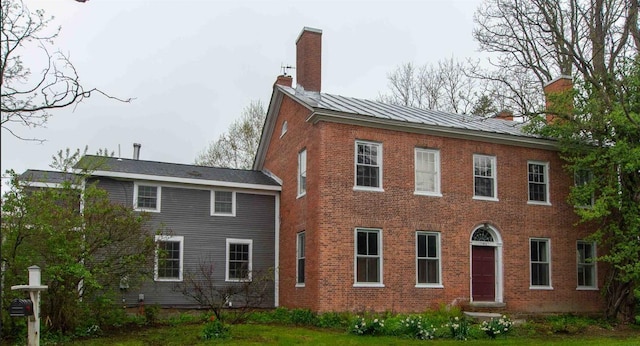 2678 Silver St, Hinesburg, VT 05461 - view of property exterior with a chimney, brick siding, and a standing seam roof