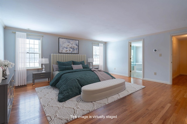 bedroom featuring ornamental molding, wood finished floors, baseboards, and connected bathroom