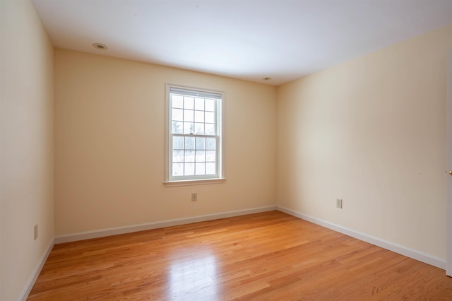 spare room with light wood-style flooring and baseboards
