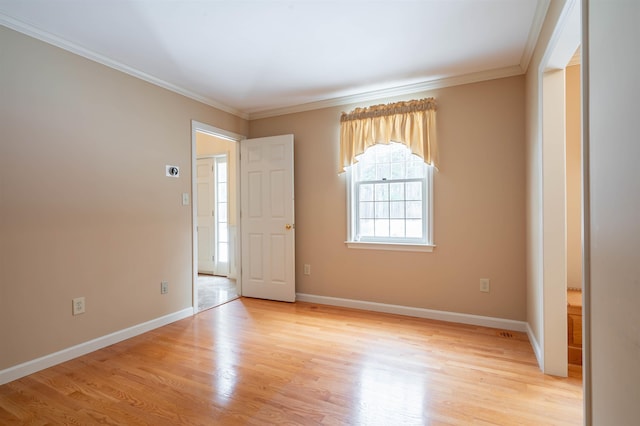 foyer with light wood-style floors, baseboards, and ornamental molding