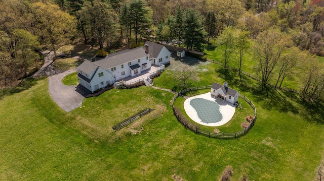 view of subject property with a heavily wooded area