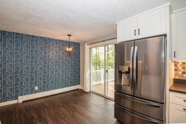 kitchen with stainless steel fridge with ice dispenser, wallpapered walls, baseboards, white cabinetry, and dark wood-style flooring