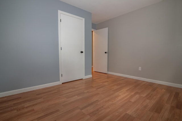unfurnished room featuring light wood-style flooring and baseboards