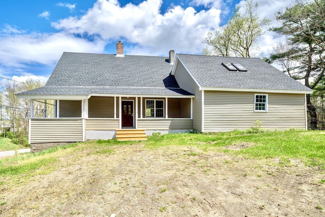 view of front facade with covered porch, a chimney, and a shingled roof