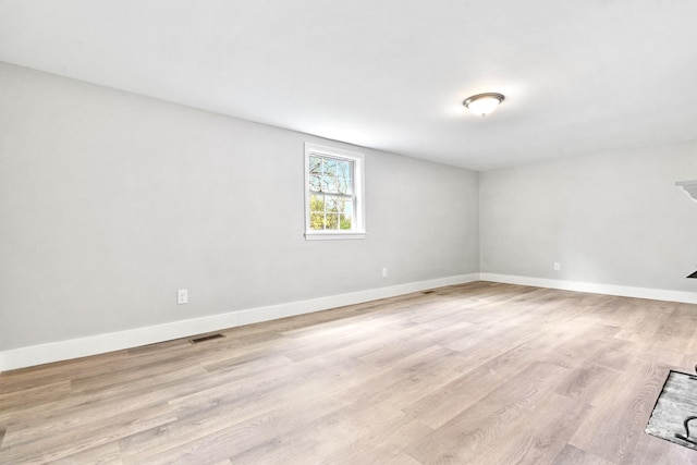 unfurnished room featuring light wood-style flooring and baseboards