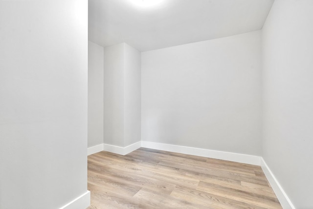 unfurnished room featuring wood finished floors and baseboards